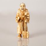 old signed netsuke of man holding instrument. early 1900 Japan