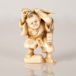 signed netsuke of boy holding an "inro" 19th/early 20th c. Japan
