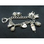 Vintage silver charm bracelet with 9x charms 65 grams London 1978