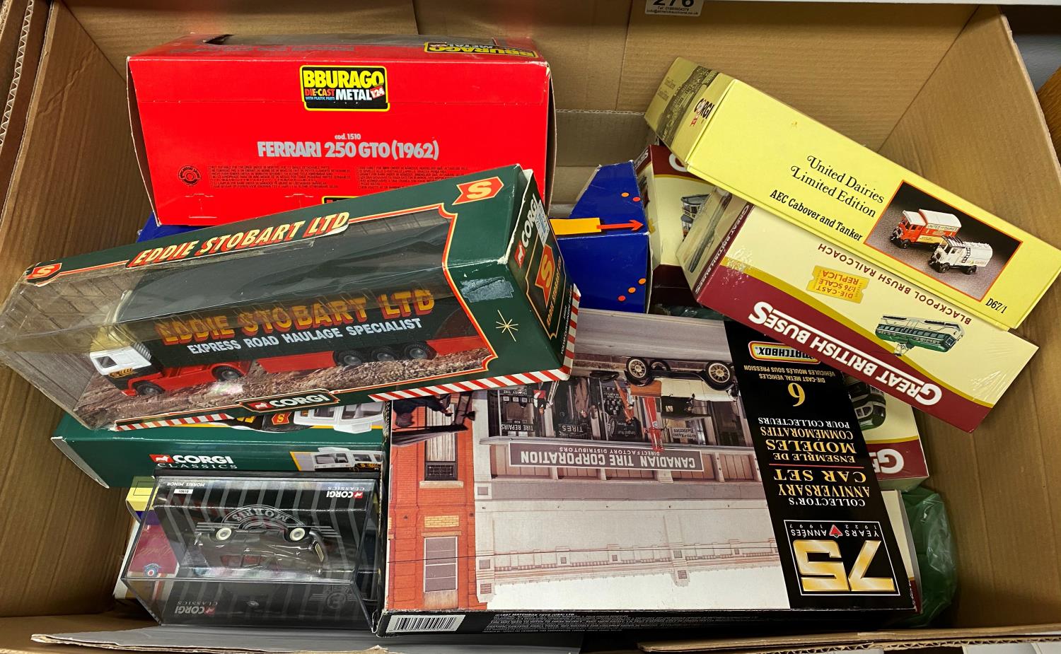 Box containing corgi Eddie Stobart trucks and other cars