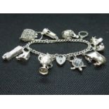 Vintage silver bracelet with 11 charms London 1970 44g