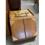 Wooden coal scuttle with mechanical doors attached via handle