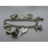 Vintage silver charm bracelet with 8 charms lock and chain Birmingham 1972