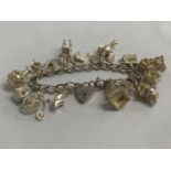 Vintage silver charm bracelet with 17 charms HM London 1973 55g