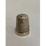 Silver Birmingham thimble by IS and Co in a thimble holder