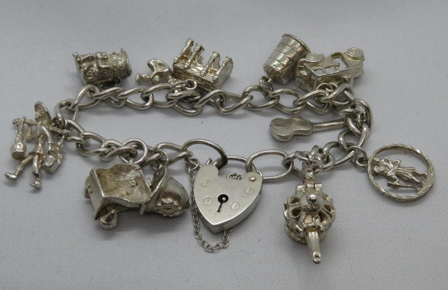 Vintage silver charm bracelet with 11 charms London 1976 38g