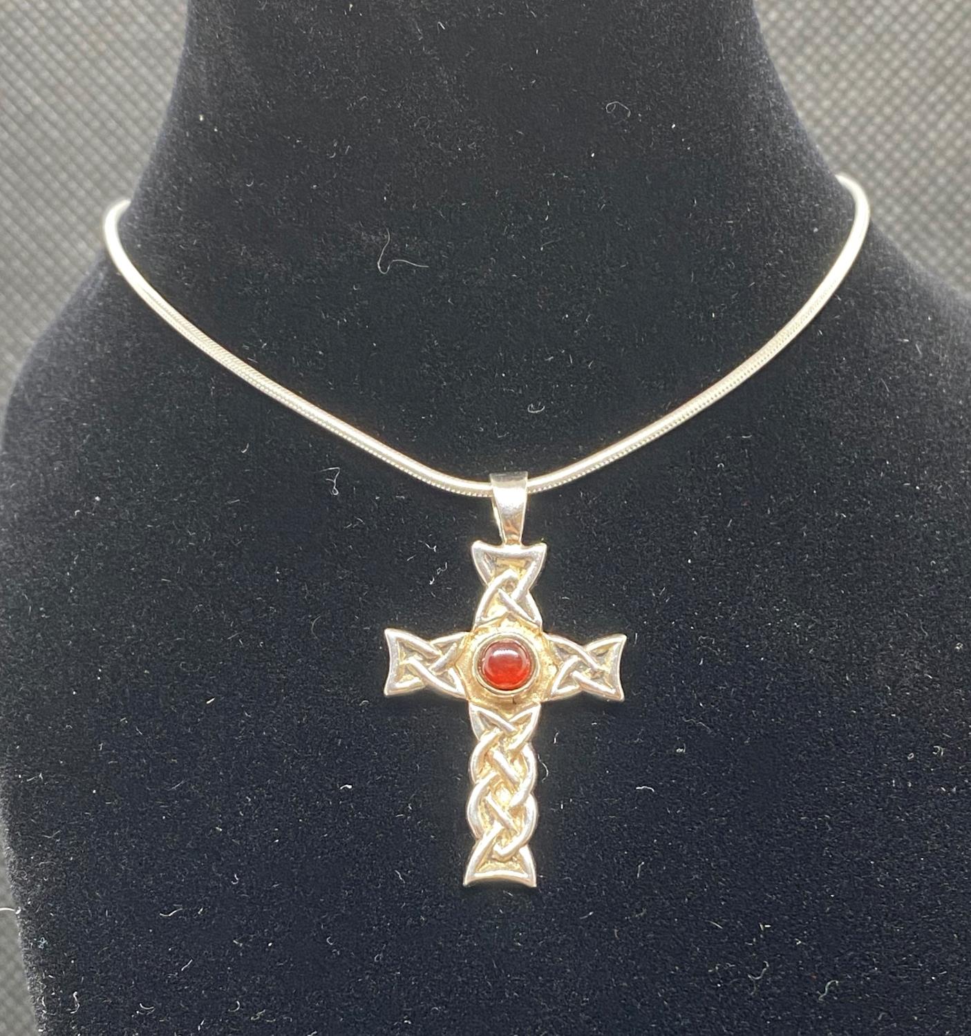 Silver Celtic design cross with cabochon garnet engraved in Gaelic on reverse Mo Gra Thu ( You are