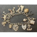 Vintage silver charm bracelet with lock and chain and 14 charms 49g