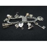 Vintage silver charm bracelet with 12x charms every link HM Lion Passant and full HM padlock