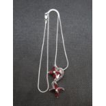 Silver pendant on 18" chain set with garnets
