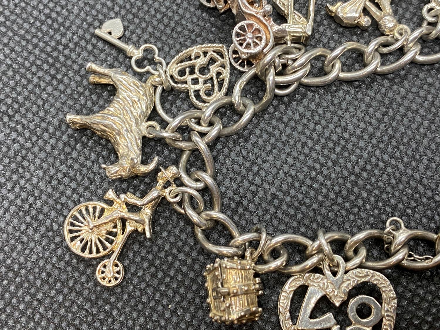 Vintage silver charm bracelet with lock and chain and 14 charms 49g - Image 2 of 2