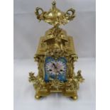 Ormolou clock with hand painted procelain dial of cherubs with Paris movement and lidded urn top 12"
