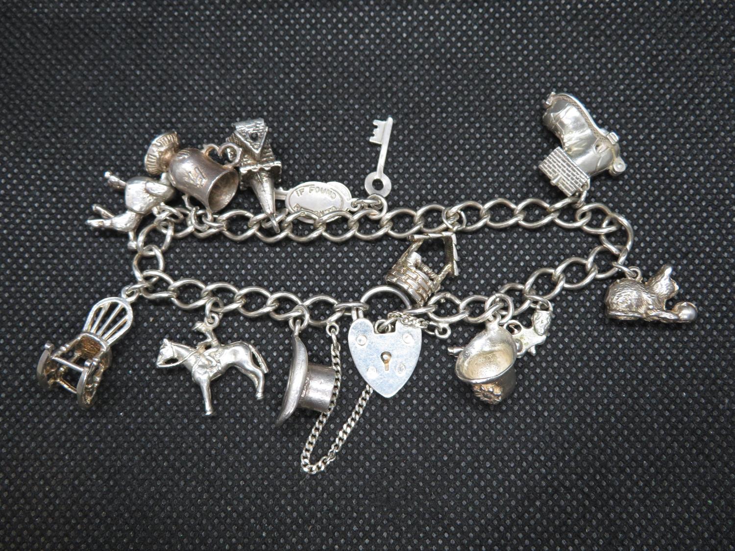 Vintage silver charm bracelet with 12x charms Birmingham 1977 36g