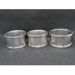 2x silver napkin rings and one plated napkin ring