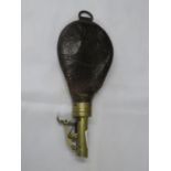 Old powder flask in leather and brass