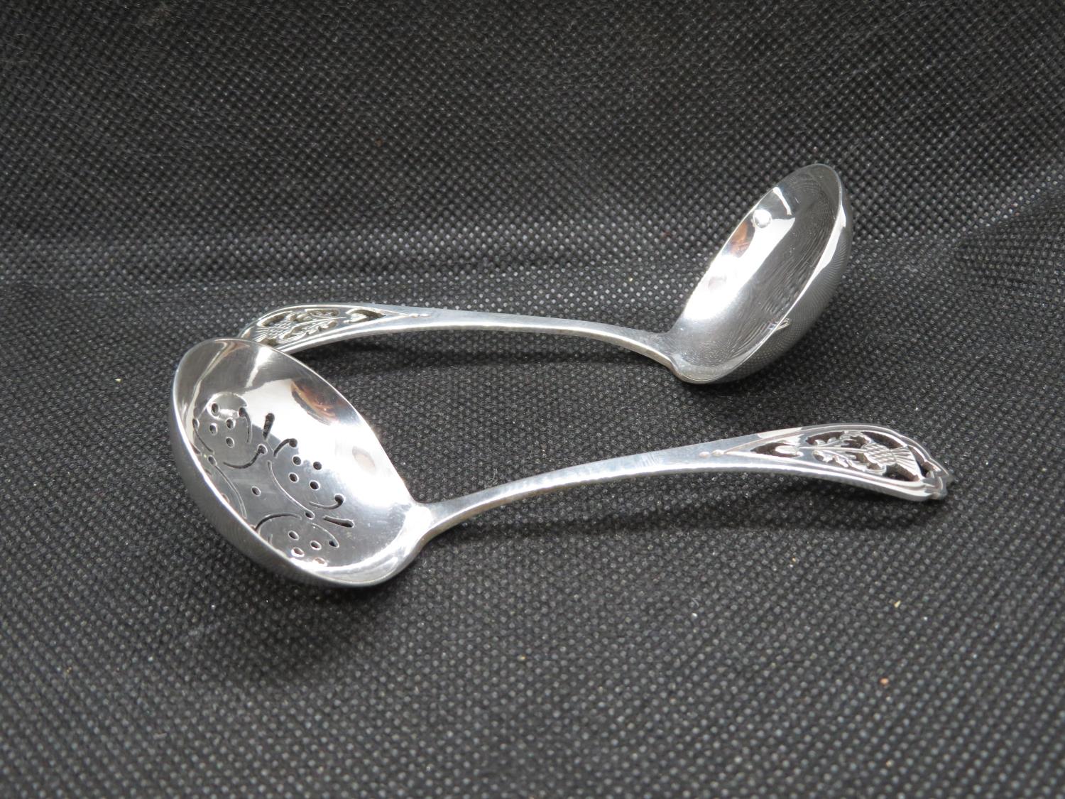 Scottish silver sugar sifters with hand pierced thistle finial and matching sauce ladle 34g.