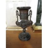 12" Urn on wooden plinth possibly bronze