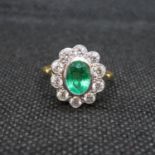 18ct gold and platinum cluster ring with central oval emerald approx 1.2ct with 10 natural brilliant
