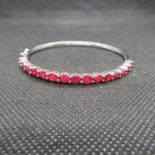 Stunning large silver bangle set with 15x oval cut rubies 2.5" x 2.25" 10.3g