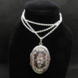 Silver floral engraved locket on 20" silver chain 16.8g