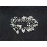 Silver charm bracelet HM London 1978 with 20 charms 62.5g