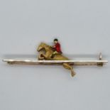 9ct HM brooch with gold horse and foxhunter rider with enamel in black and red