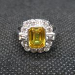 Art Deco platinum ring set with emerald cut yellow sapphire over 2cts surrounded by 14 round and