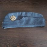 A WWII RAF blue cloth flat cap, c.1940. With brass badge and buttons.