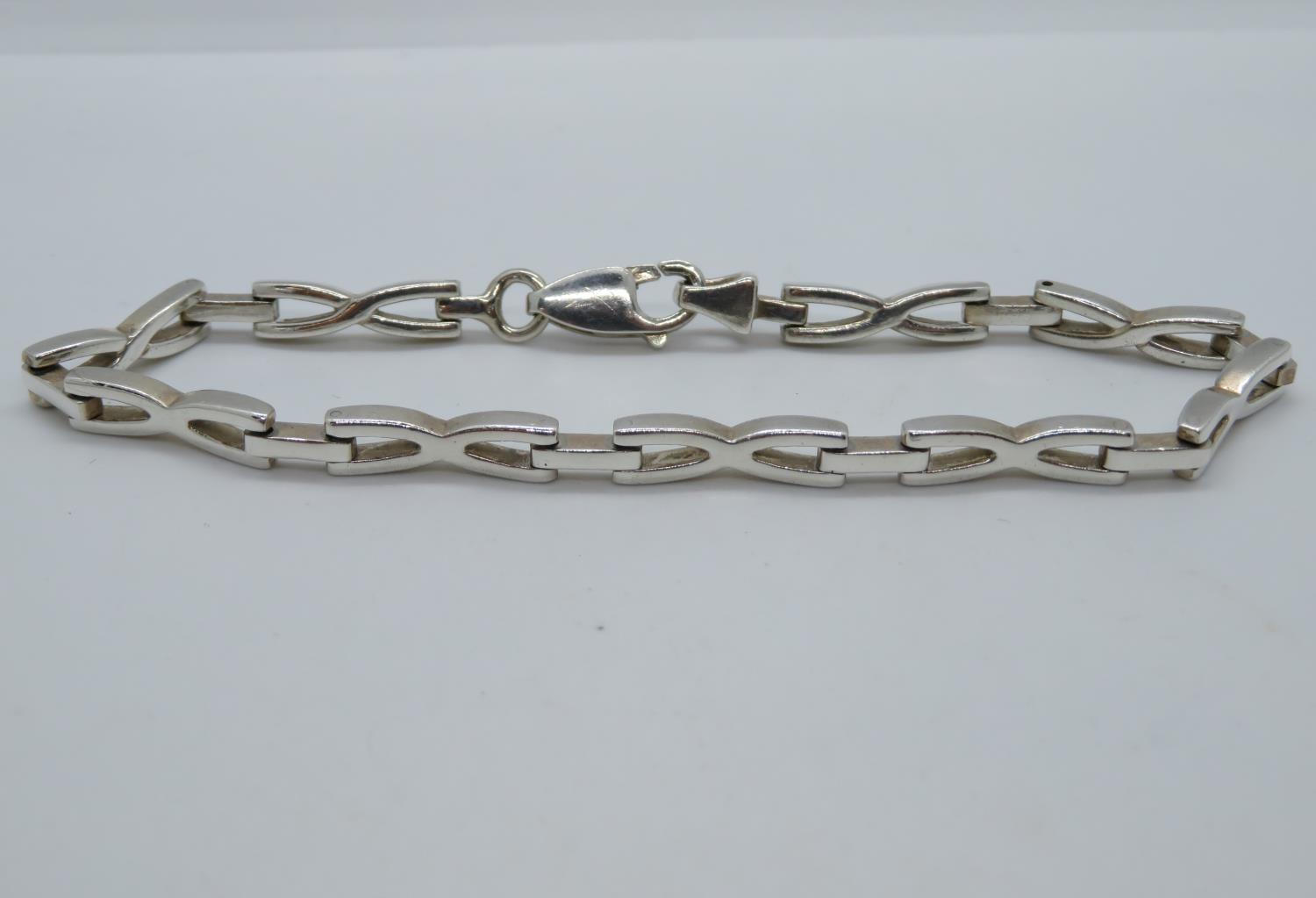 HM SILVER CROSSOVER BRACELET 8" LONG 12.9G