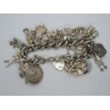 Heavy silver charm bracelet 29x charms 114g