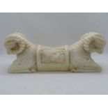 Ornately carved double Ram's head pillow