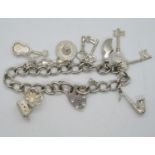 Silver charm bracelet 8x charms 27g