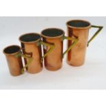 Graduated set of copper measuring cups from .25 - full