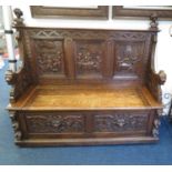 Large heavily carved wooden monk's bench with storage and seating - possibly early Victorian