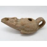 Roman oil lamp with human face