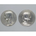 2x coin sized reliefs of two young ladies by G. Devreese in silver