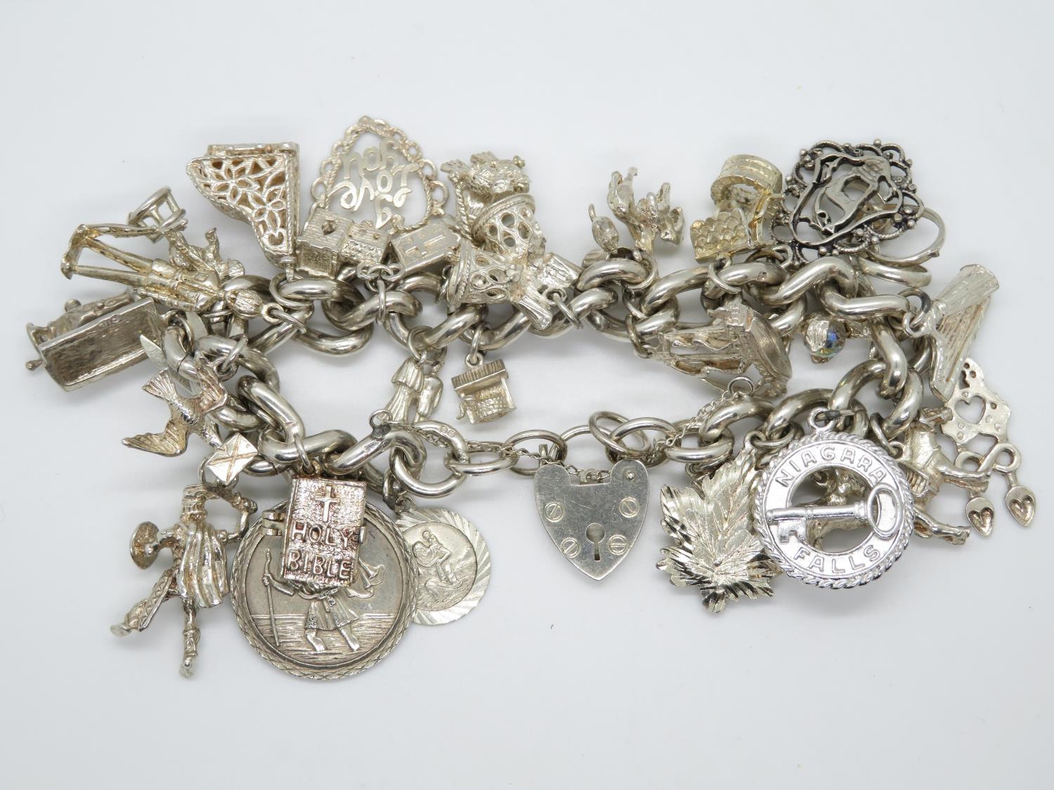 Heavy silver charm bracelet with 29 nice charms London 1978 114g