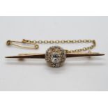 .4ct diamond set with 12x. .1ct diamonds surrounding central stone on 15ct brooch with safety