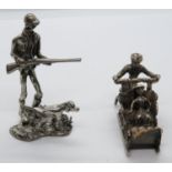 2x HM AR800 figures - 1x shotgun and dog and other pushing sleigh with passenger. 40.8g