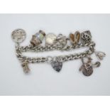 Vintage silver charm bracelet with 9x charms HM London 1978 52g