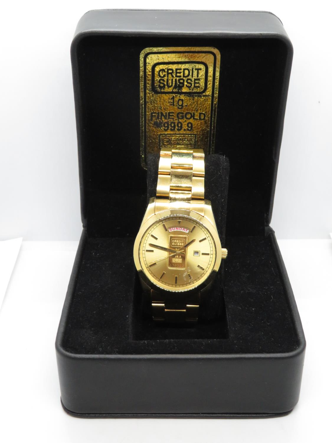 Working boxed Credit Suisse 1g fine gold displayed on face of watch