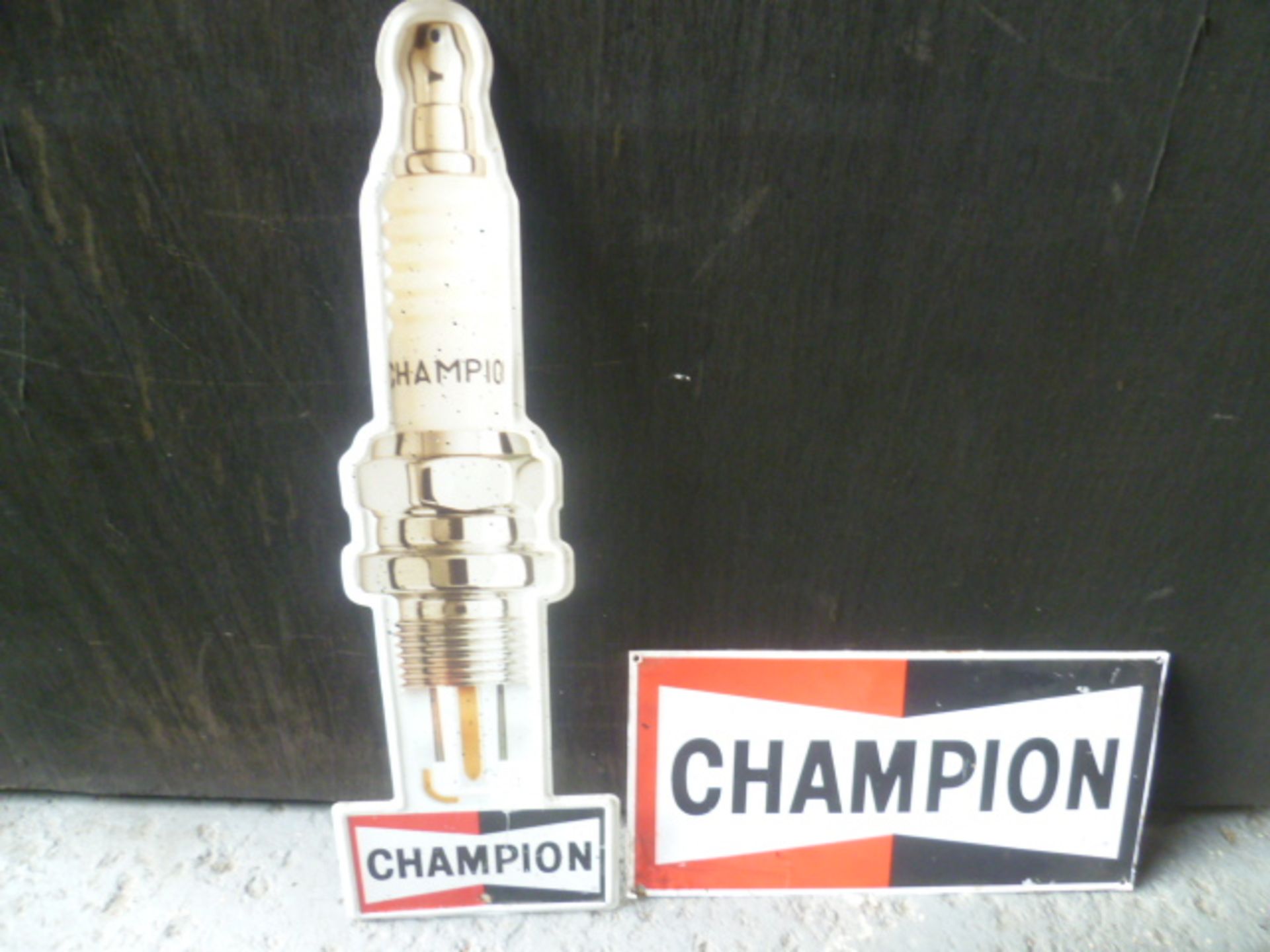 Two Champion Spark Plug Tin Signs