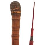 A MEIJI PERIOD JAPANESE GADGET WALKING CANE, the bamboo cane carved with Geisha girls, foliage and