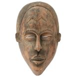 A 19TH CENTURY BURKINO FASO CARVED WOODEN TRIBAL MASK, approximately 33cm high and of characteristic