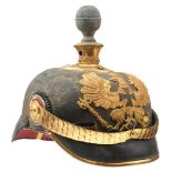 A PRUSSIAN VOLUNTEER ARTILLERY OFFICER'S PICKELHAUBE, the black leather skull with gilt fittings