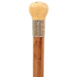 A LATE VICTORIAN WALKING CANE, the ivory pommel incorporating a compass (not working and probably