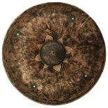A TIBETAN BRONZE SHIELD, the 35.5cm dished concave body with tramline border, central foliate