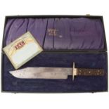 A CASED WOSTENHOLM & SONS BOWIE KNIFE, 26cm clipped back blade etched to resemble damascus,