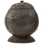 AN INDIAN CARVED COCONUT BOWL, the associated cover delicately carved with scrolling foliage and