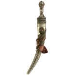 A WAHABITE JAMBIYA, 34cm sharply curved blade, characteristic white metal filigree decorated hilt